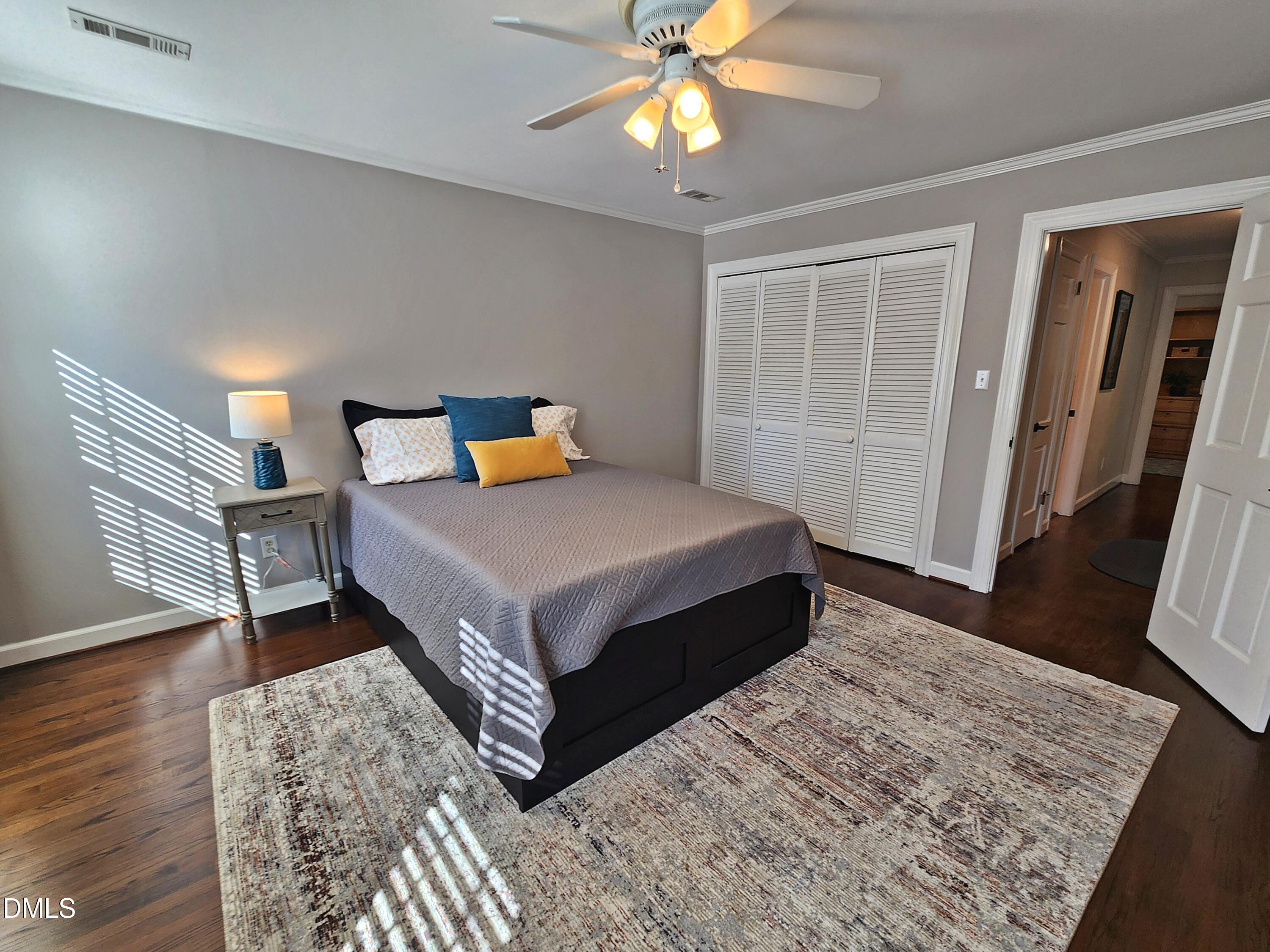 4704 Oak Park Road Raleigh, NC 27612 - Photo 47 of 62 a bedroom with a bed and wooden floor