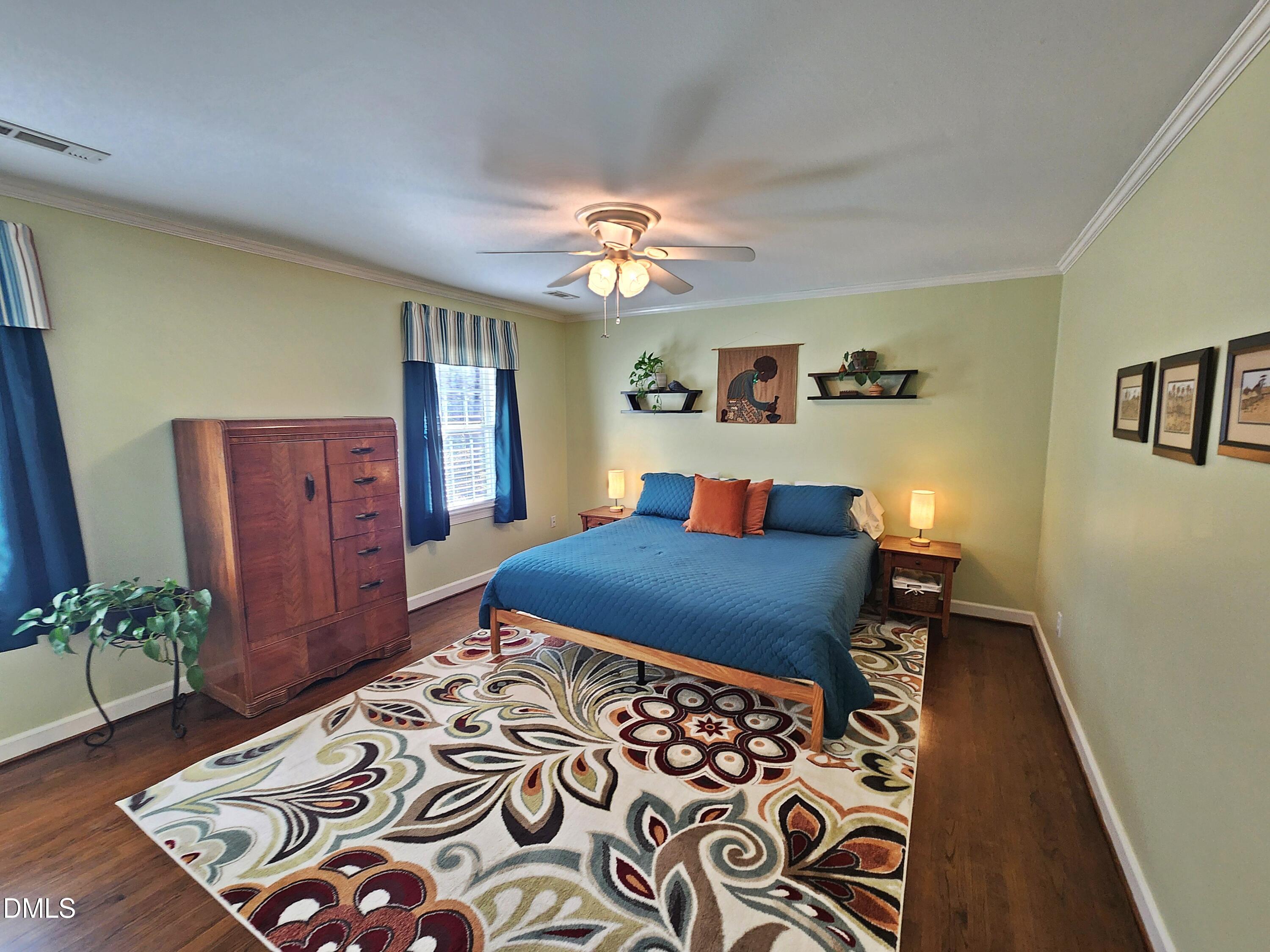 4704 Oak Park Road Raleigh, NC 27612 - Photo 48 of 62 a bedroom with a bed and a chandelier