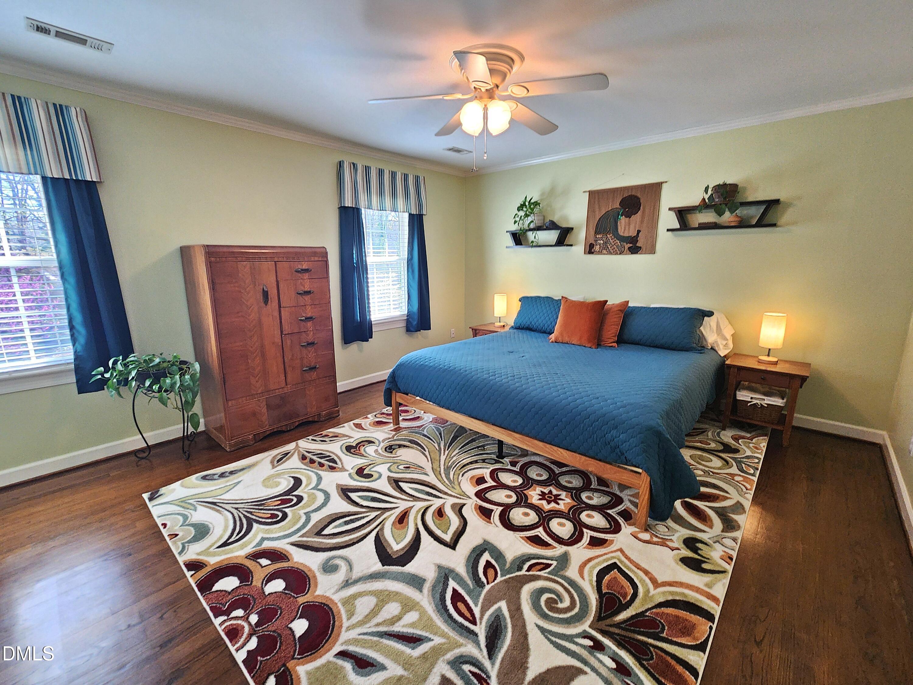 4704 Oak Park Road Raleigh, NC 27612 - Photo 49 of 62 a bedroom with a bed and wooden floor