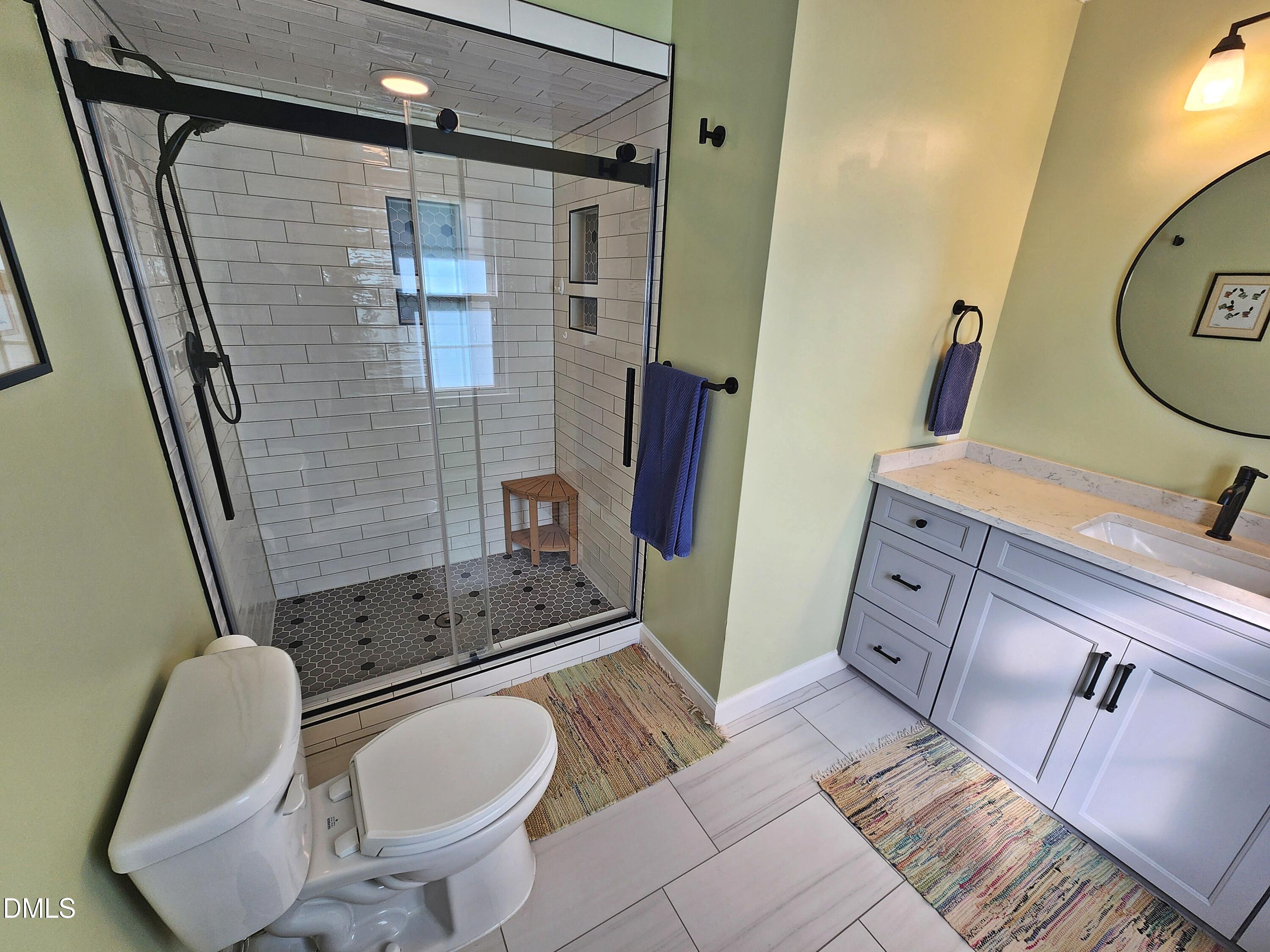 4704 Oak Park Road Raleigh, NC 27612 - Photo 52 of 62 a bathroom with a sink toilet and shower