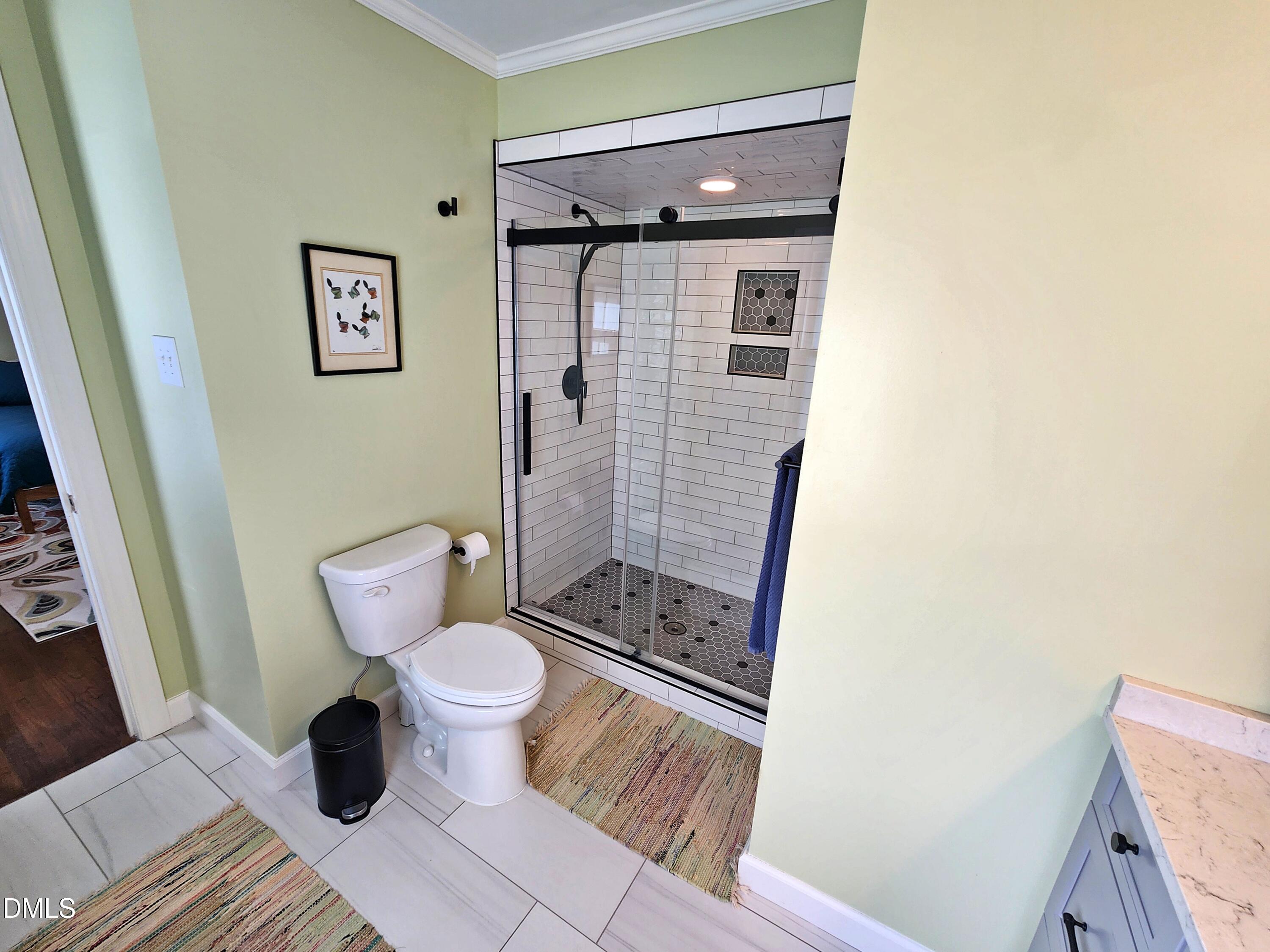 4704 Oak Park Road Raleigh, NC 27612 - Photo 53 of 62 a bathroom with a toilet and a shower