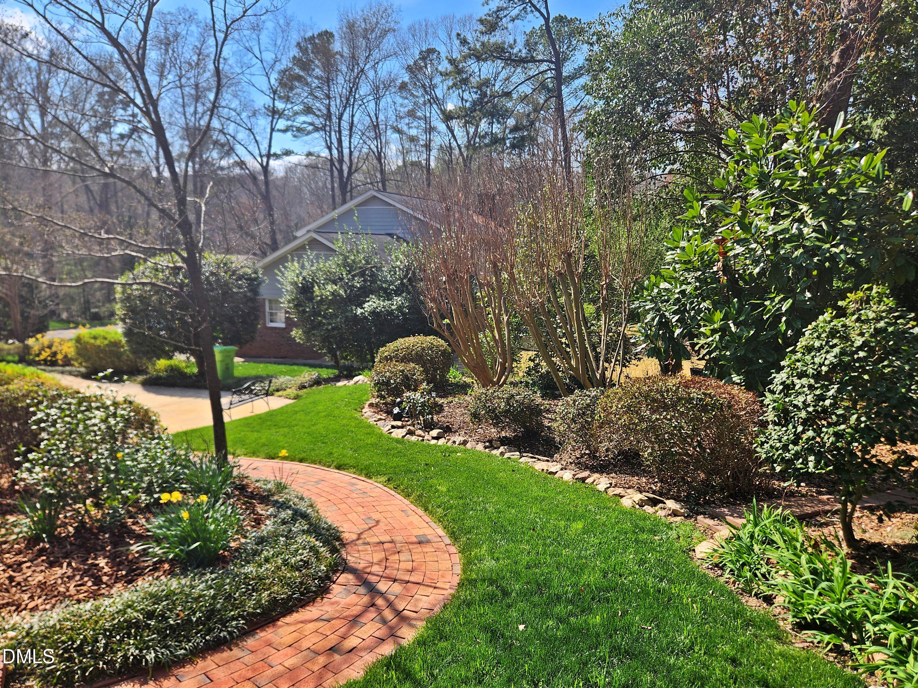 4704 Oak Park Road Raleigh, NC 27612 - Photo 5 of 62 a view of a garden with plants and large trees