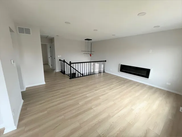 a view of a room with wooden floor