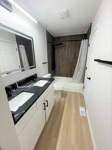 a bathroom with a double vanity sink and mirror