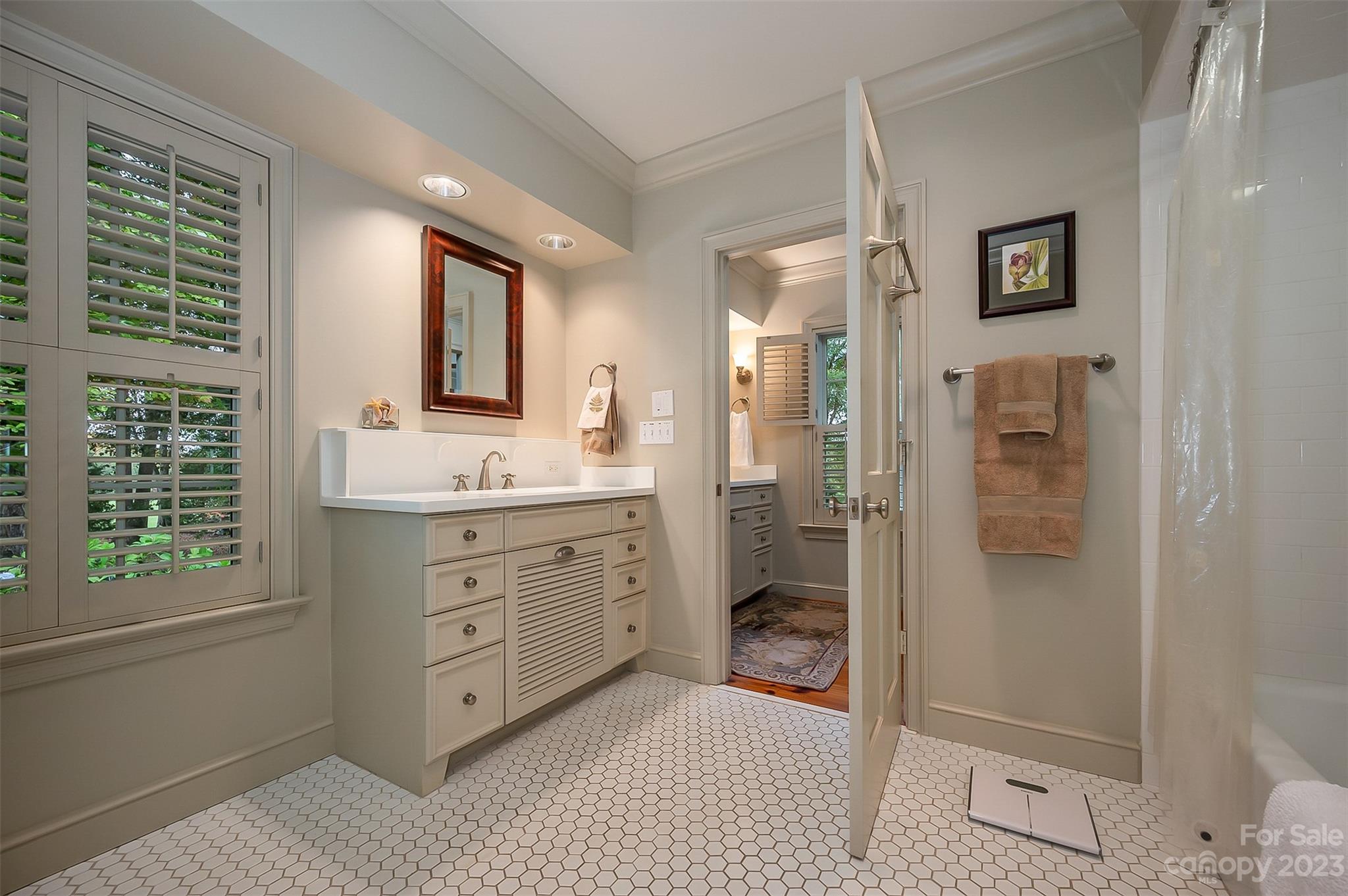 1389 Landrum Road Columbus, NC 28722 - Photo 12 of 46 a bathroom with a double vanity sink mirror and shower