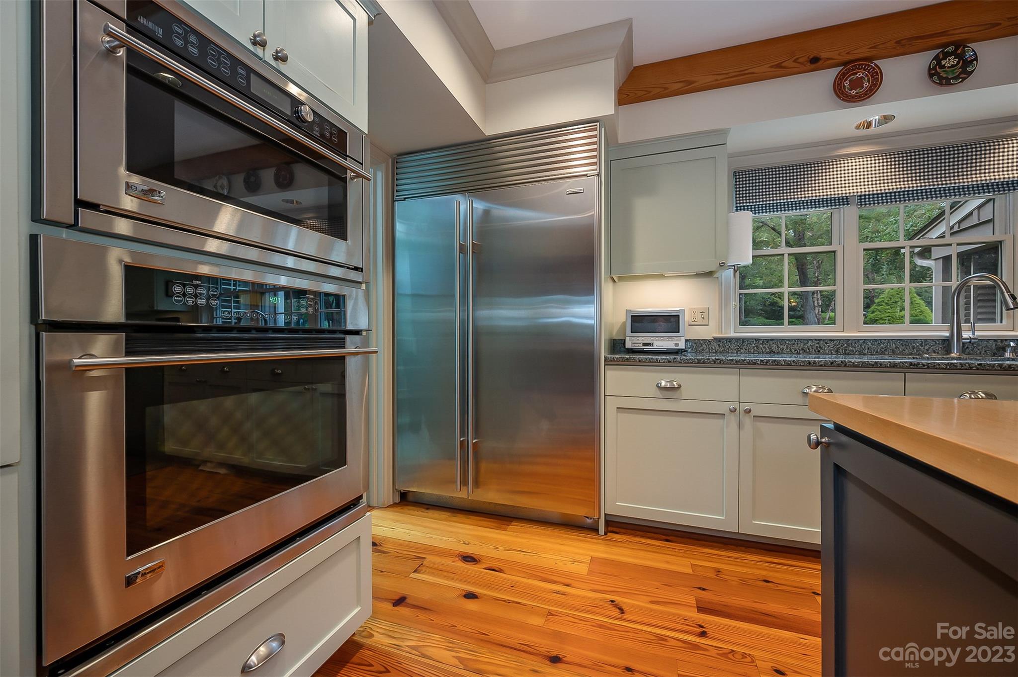 1389 Landrum Road Columbus, NC 28722 - Photo 27 of 46 a kitchen with stainless steel appliances granite countertop a stove microwave and refrigerator