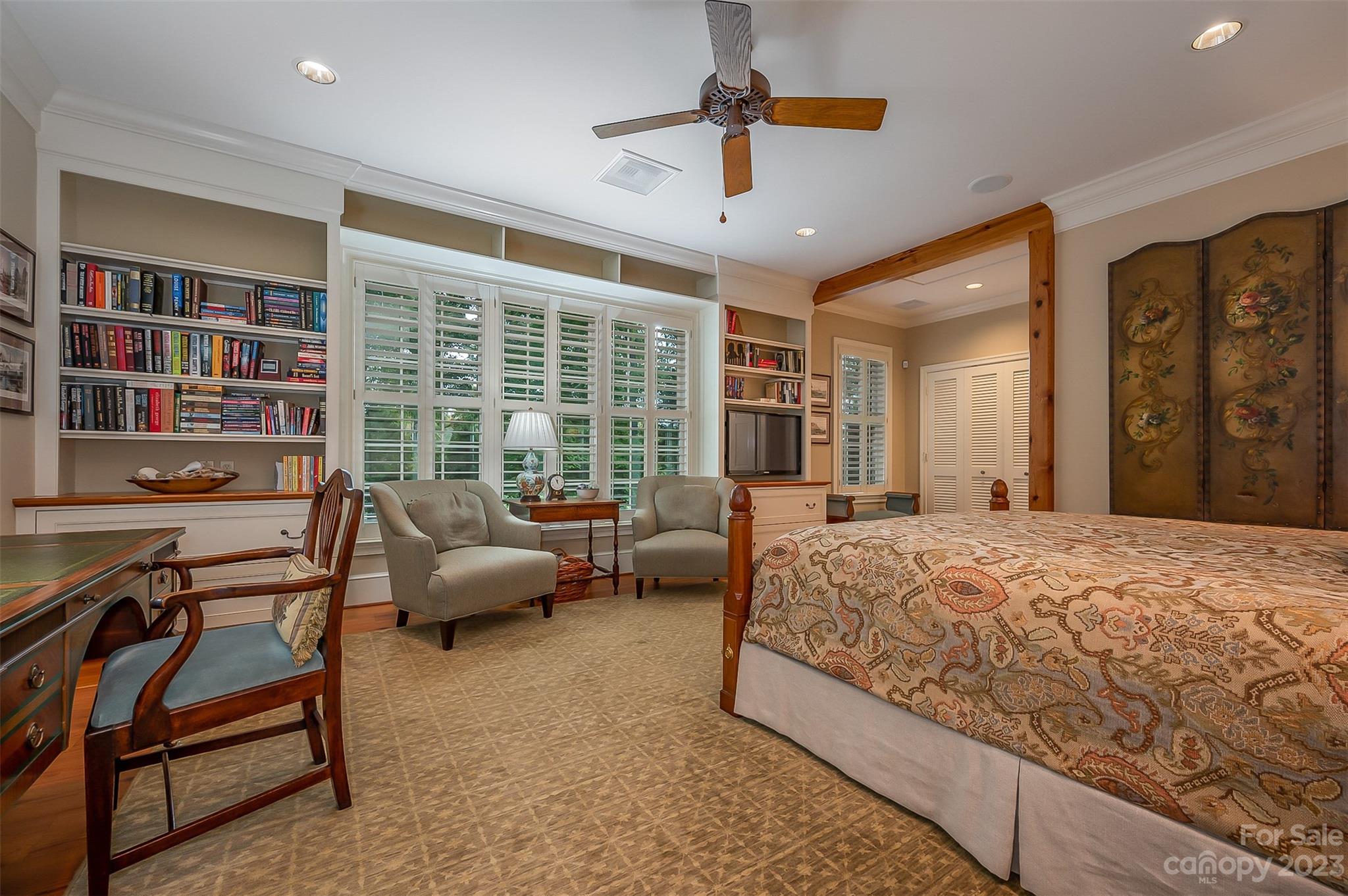 1389 Landrum Road Columbus, NC 28722 - Photo 36 of 46 a bedroom with a bed a bookshelf and a bookshelf
