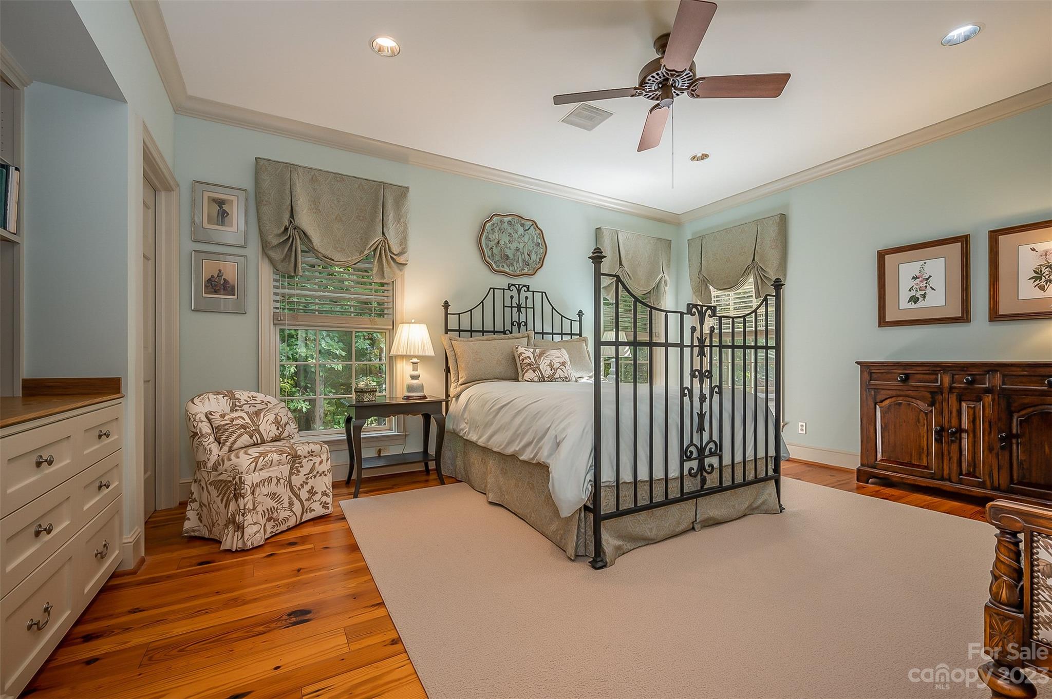 1389 Landrum Road Columbus, NC 28722 - Photo 39 of 46 a bedroom with a bed and a chandelier