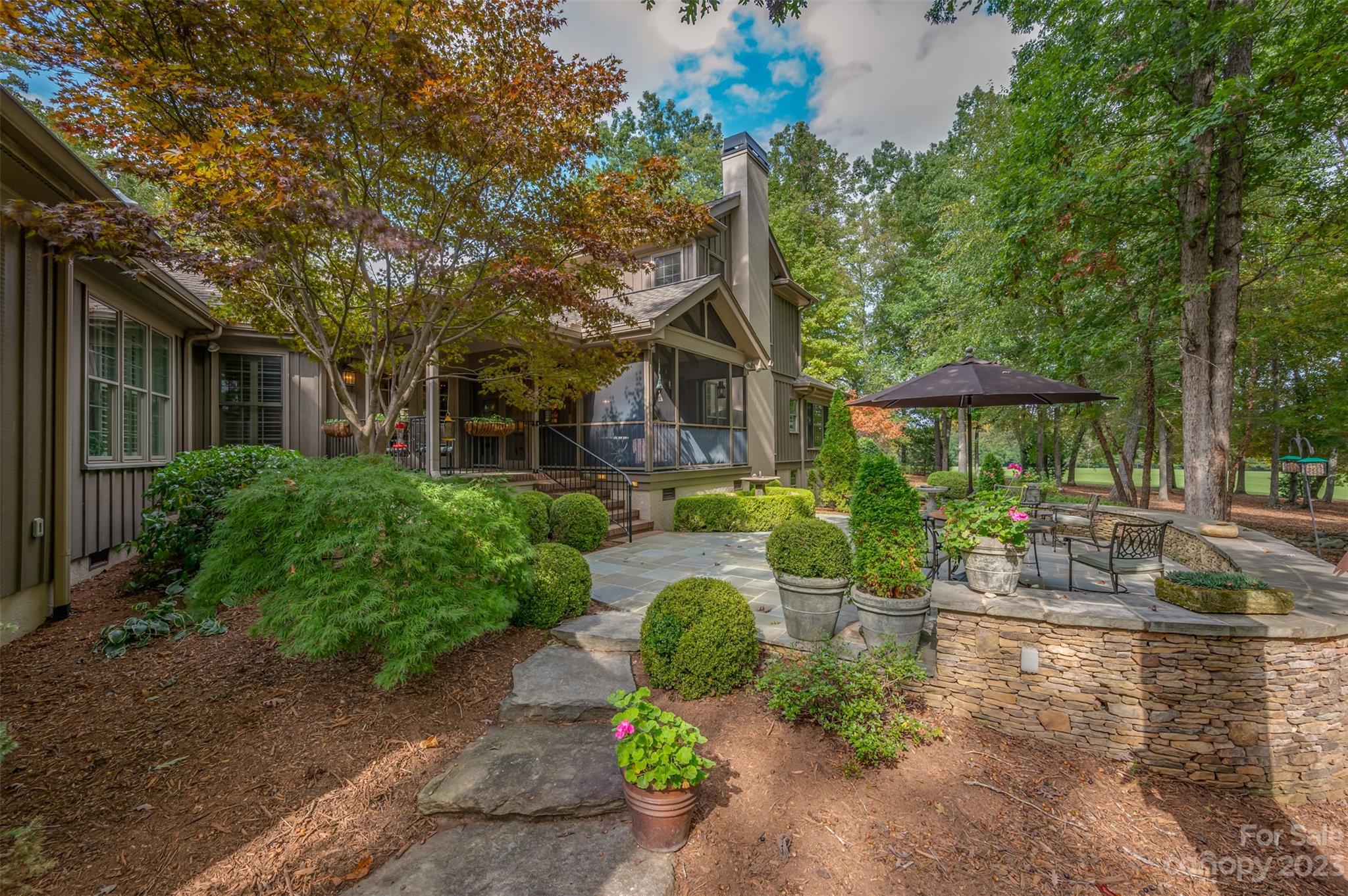 1389 Landrum Road Columbus, NC 28722 - Photo 5 of 46 a front view of a house with garden and patio