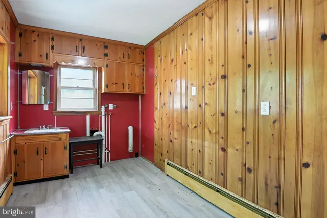 a view of a kitchen with furniture and wooden floor