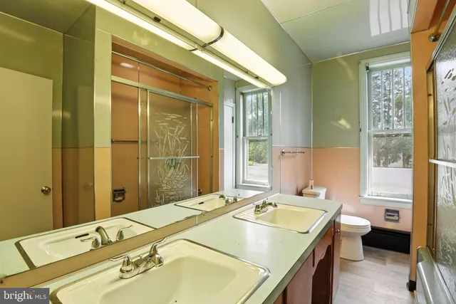a spacious bathroom with a granite countertop sink and a large mirror