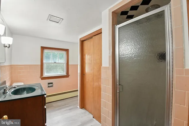 a view of a bathroom with a sink and a mirror