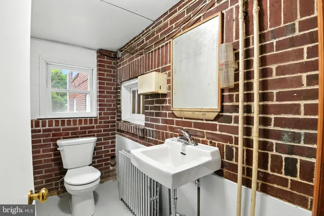 a bathroom with a sink toilet and mirror