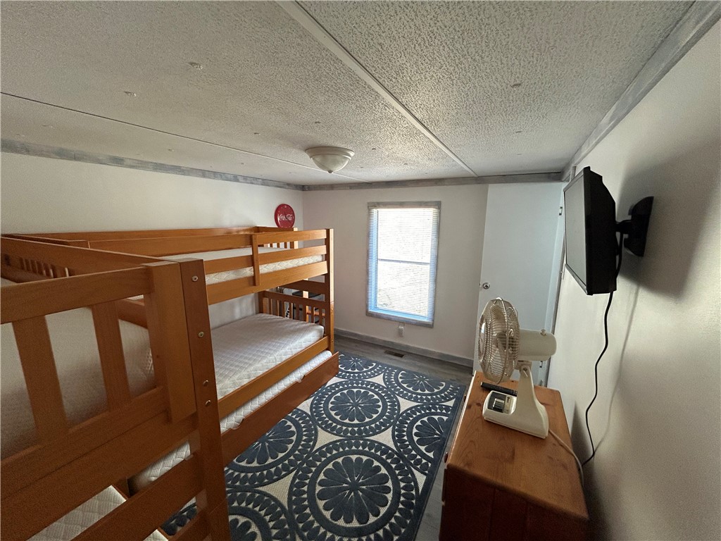 43 Sunset Cove Road Abbeville, SC 29620 - Photo 15 of 41 This cozy bedroom offers practical bunk beds and ample natural light.