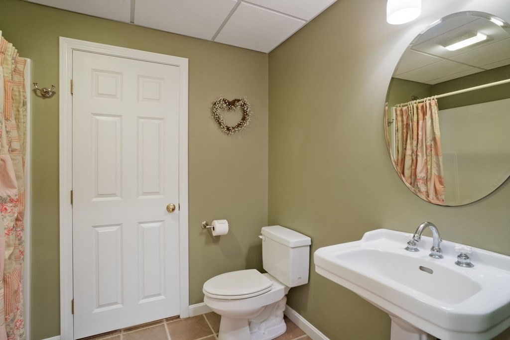 22 Falcon Ridge Drive Hopkinton, MA 01748 - Photo 36 of 42 a bathroom with a sink a toilet and a mirror