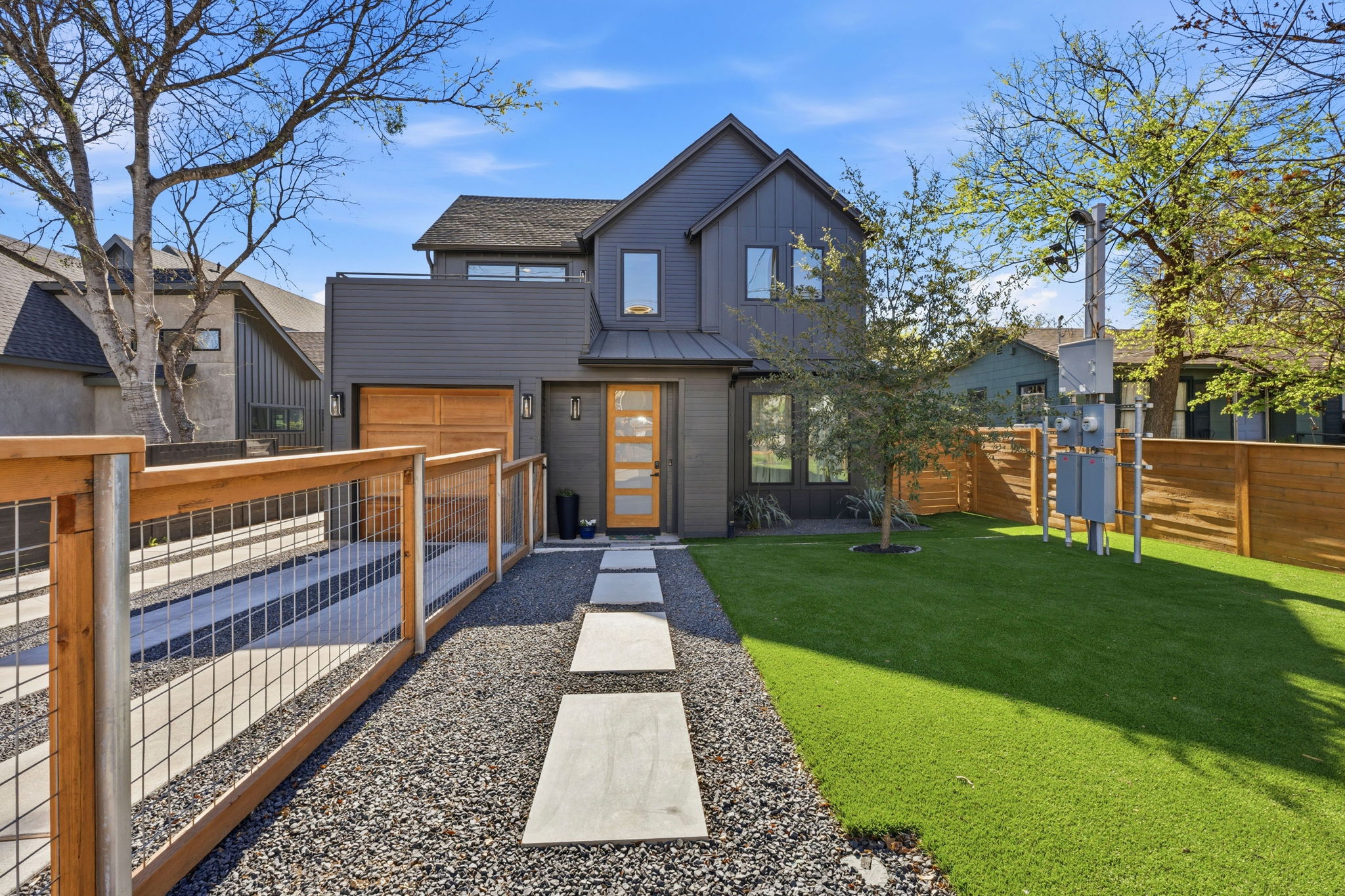 View of front of property featuring board and batten siding and an attached garage