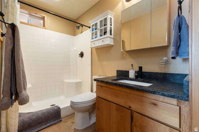 1505 West Elk Ridge Drive Alton, UT 84710 - Photo 39 of 53 Bathroom with vanity, a stall shower, and light wood-style floors