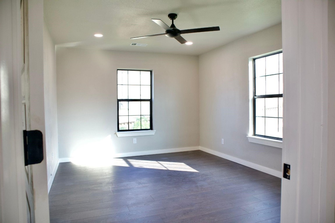 428 Van Molan Street Houston, TX 77022 - Photo 13 of 20 wooden floor in an empty room with a window