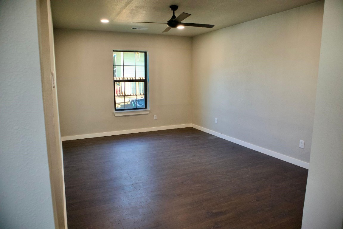 428 Van Molan Street Houston, TX 77022 - Photo 18 of 20 an empty room with wooden floor and windows