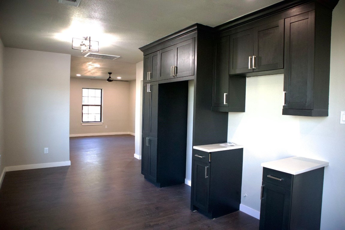 428 Van Molan Street Houston, TX 77022 - Photo 19 of 20 a kitchen with granite countertop a refrigerator a stove top oven and wooden floor