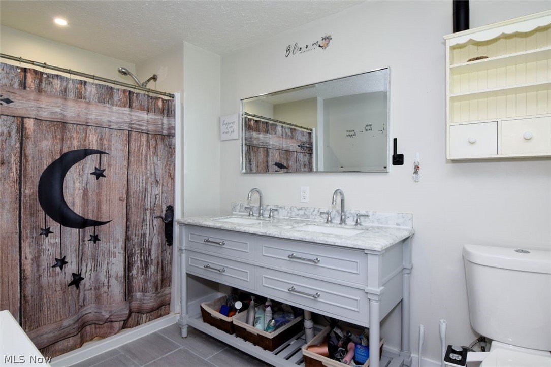 1031 East Wallings Road Broadview Heights, OH 44147 - Photo 15 of 35 Ceramic tile, double sinks & vanity, walk-in shower