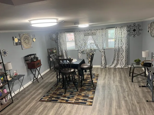a dining room with furniture and wooden floor