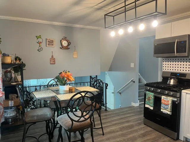 a view of a dining room with furniture and chandelier