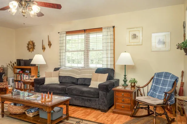 a kitchen with granite countertop a sink a window and cabinets
