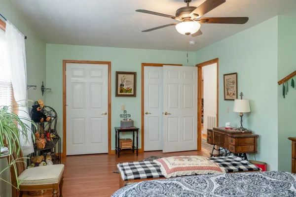 a bedroom with furniture and a window