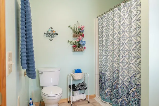 a bedroom with a bed and a potted plant
