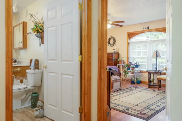 a living room with furniture a wooden floor and a flat screen tv