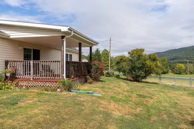 a view of a wooden house with a yard