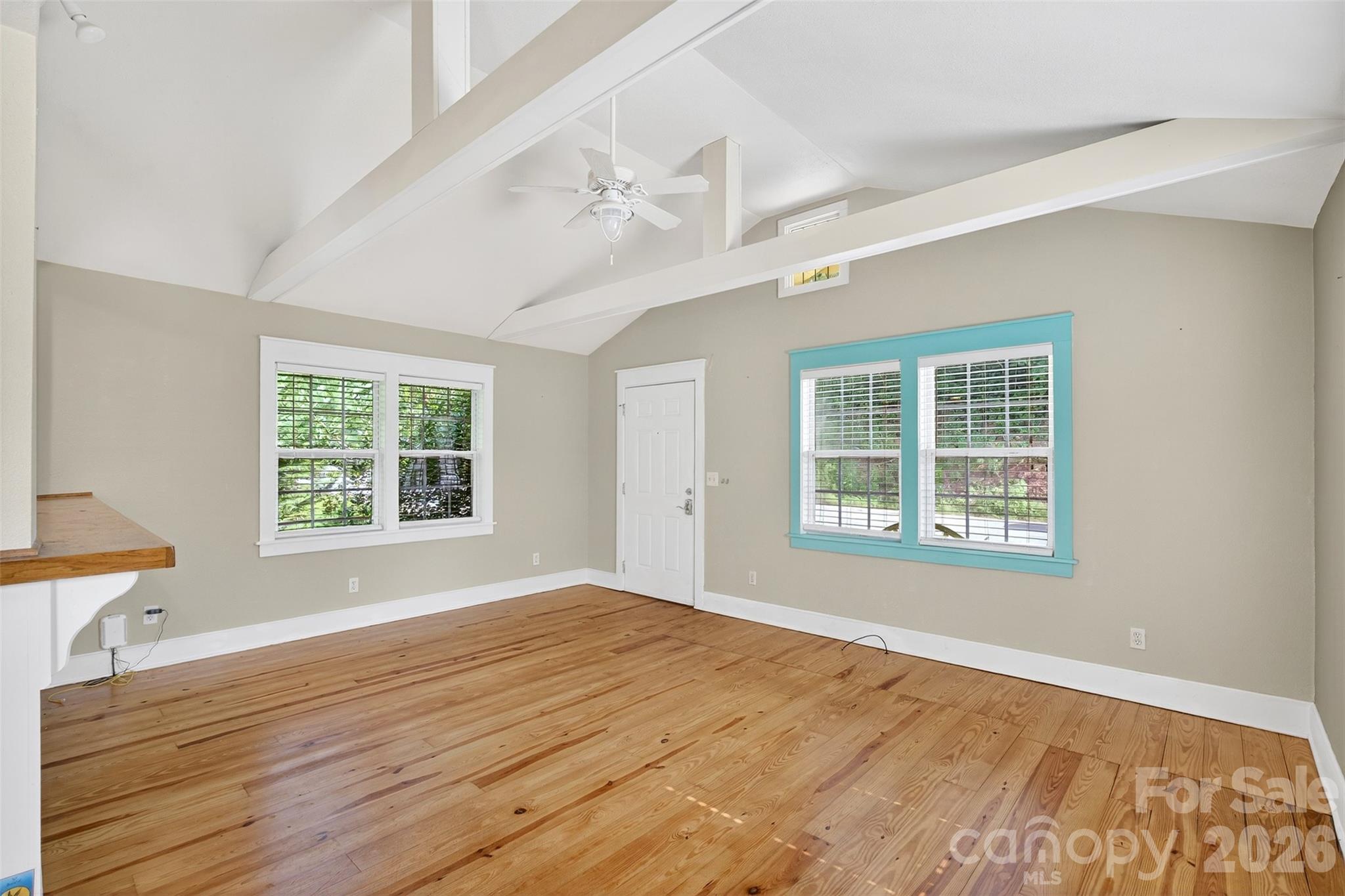 160 East Howard Street Tryon, NC 28782 - Photo 10 of 48 a view of an empty room with wooden floor and a window
