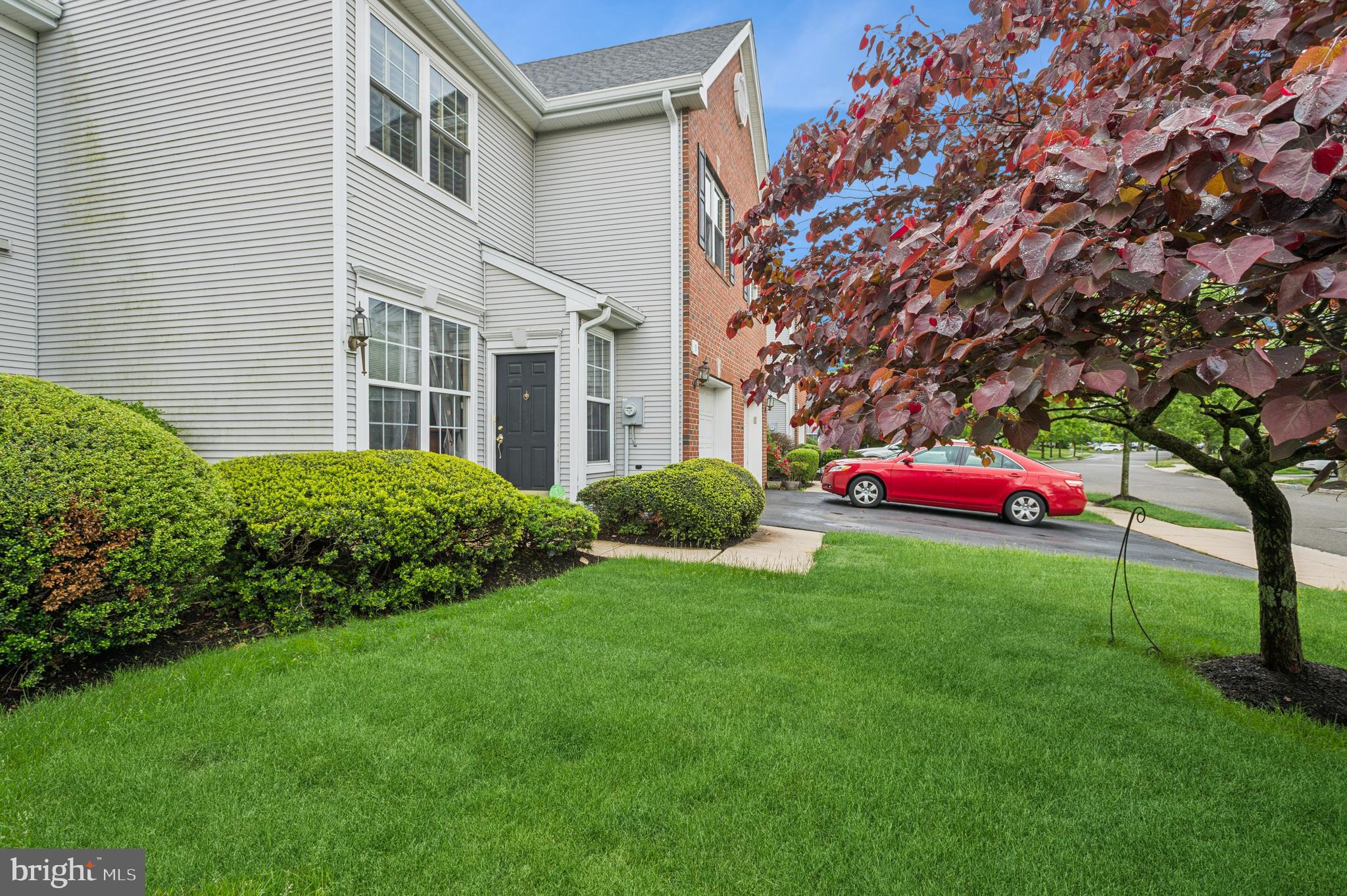a yellow and red house with a garden
