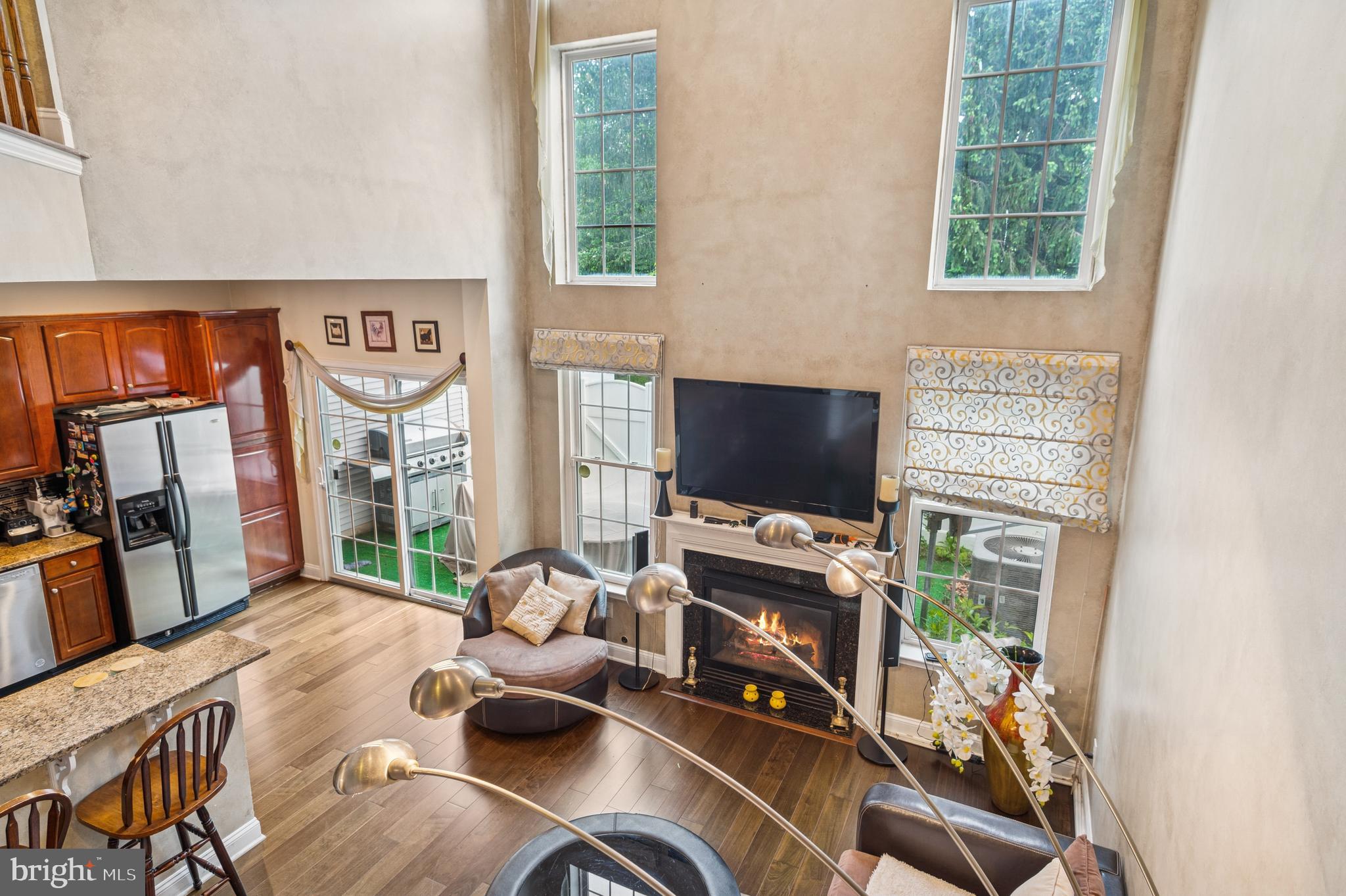 19 York Road Princeton Junction, NJ 08550 - Photo 14 of 19 a living room with furniture a flat screen tv and a fireplace