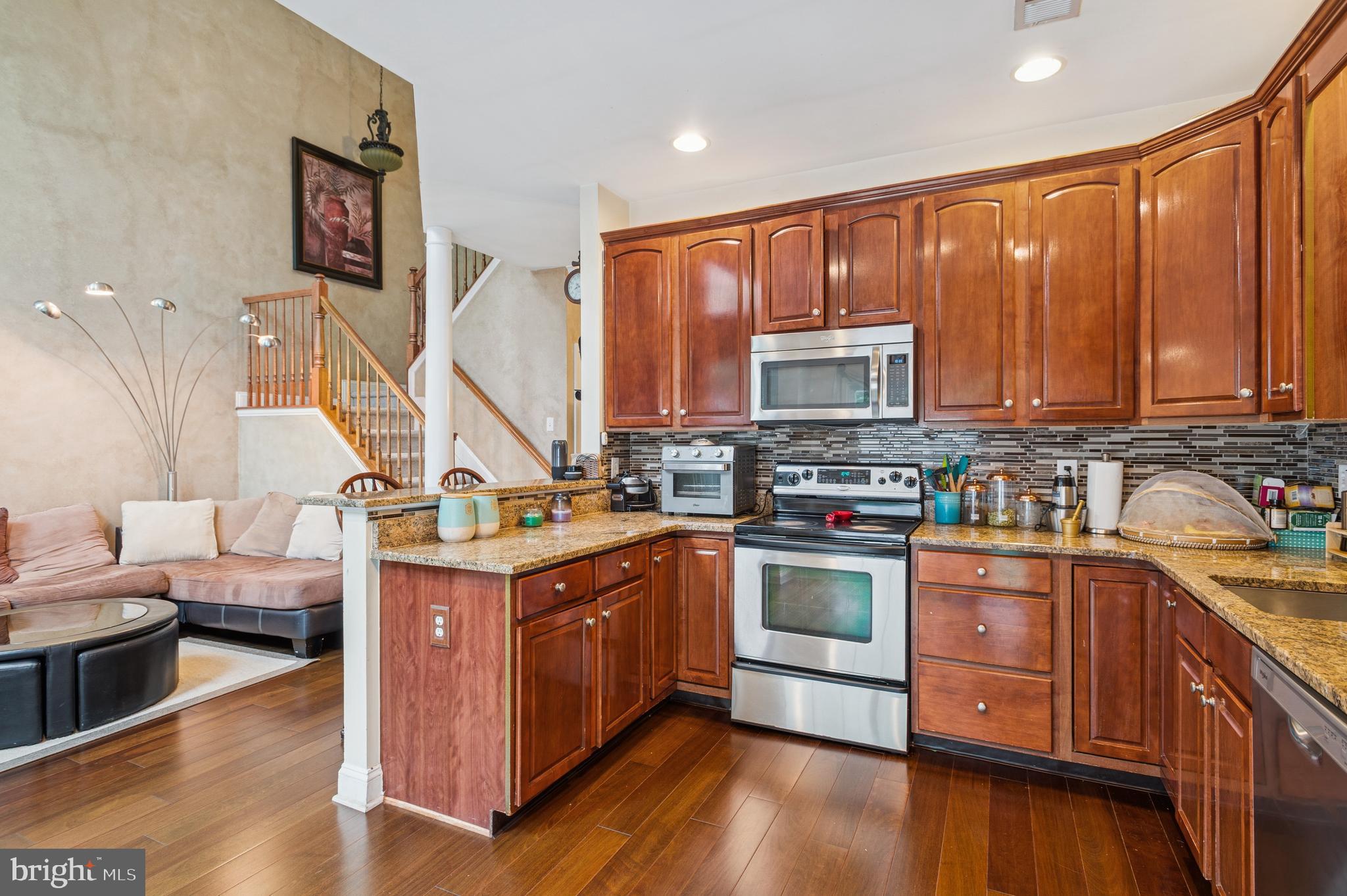 19 York Road Princeton Junction, NJ 08550 - Photo 7 of 19 a kitchen with a stove top oven sink and cabinets