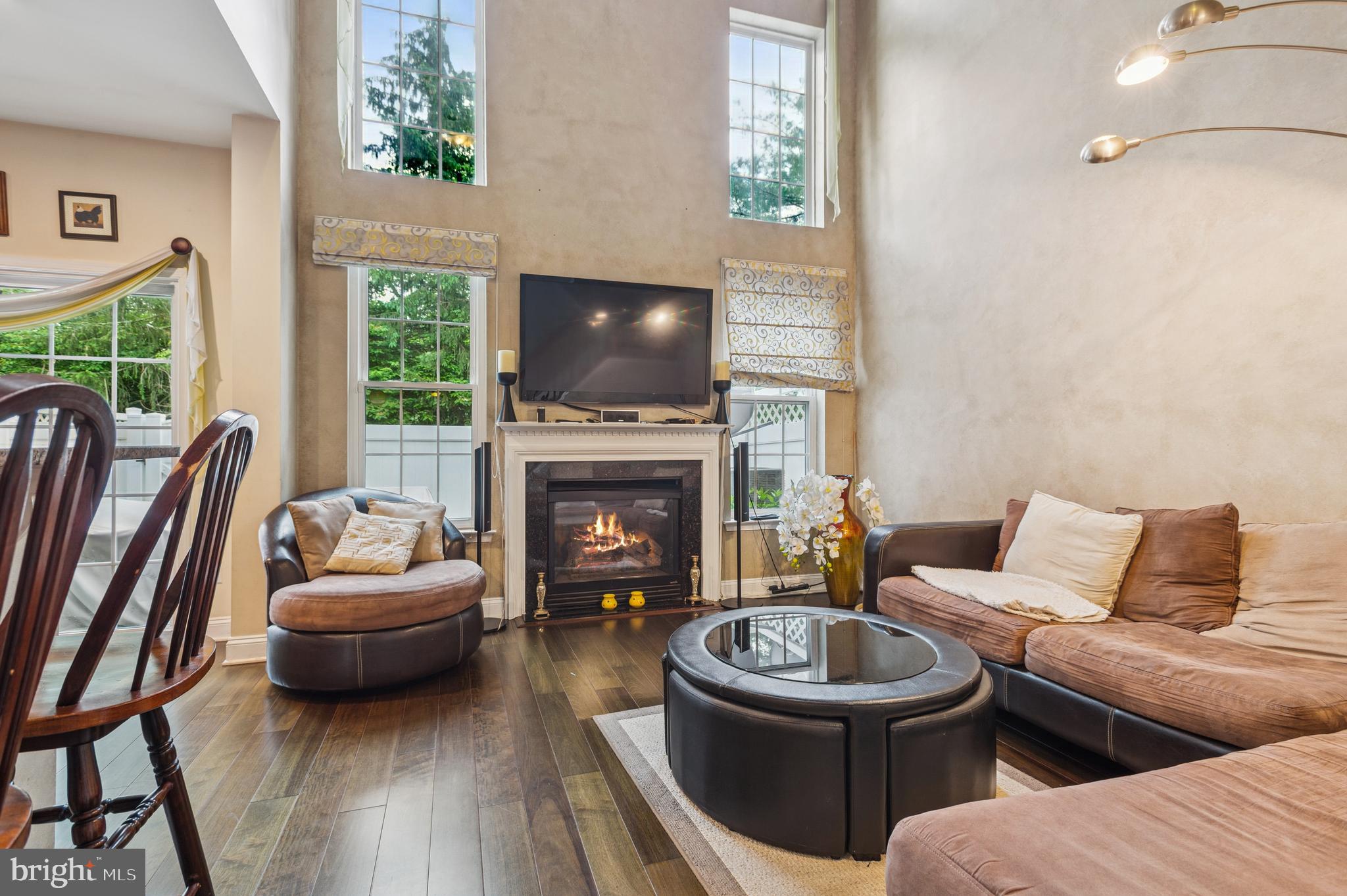 19 York Road Princeton Junction, NJ 08550 - Photo 9 of 19 a living room with furniture a flat screen tv and a fireplace