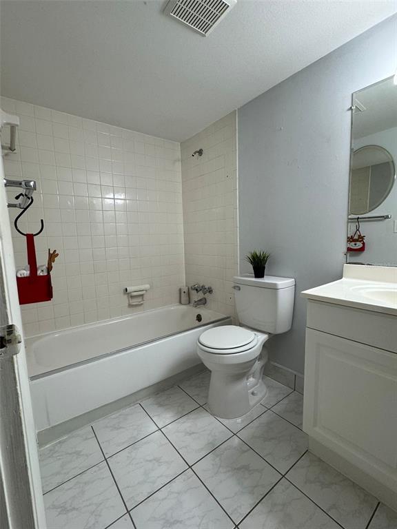 912 Lake Destiny Road, Unit G Altamonte Springs, FL 32714 - Photo 7 of 24 a white toilet sitting next to a bathroom sink and vanity