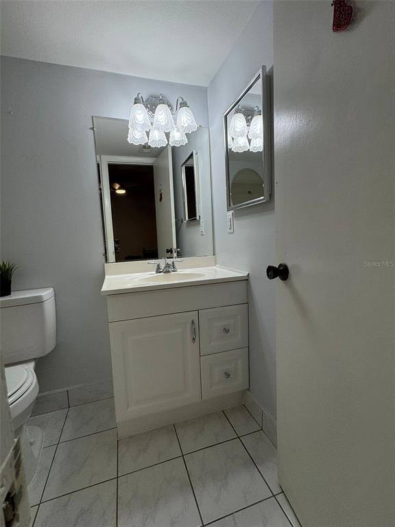 912 Lake Destiny Road, Unit G Altamonte Springs, FL 32714 - Photo 8 of 24 a bathroom with a toilet sink and mirror