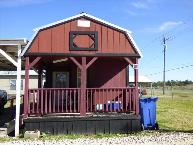 a view of a house with wooden floor next to a lake