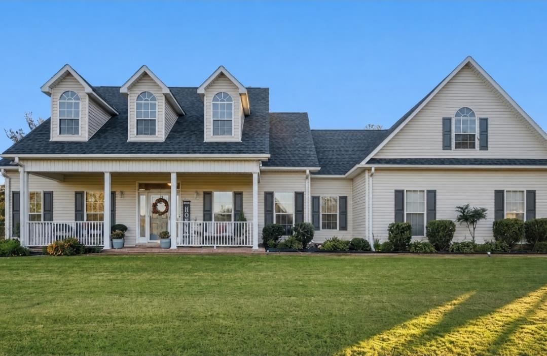 Traditional-style residence featuring a broad front lawn