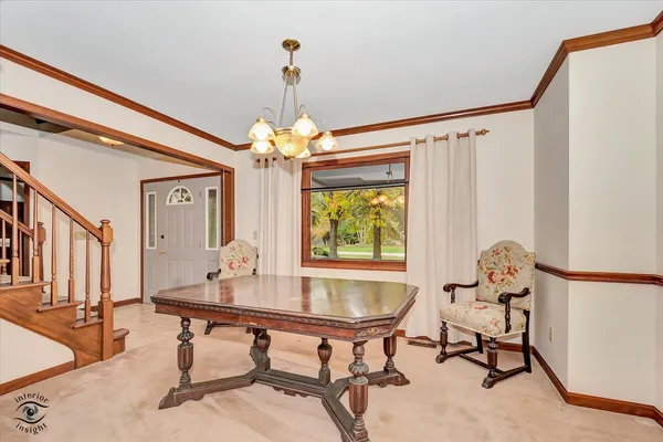 a room with chandelier fan and windows