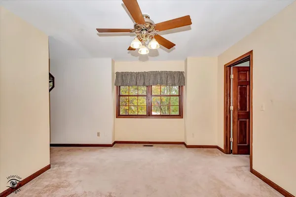 a view of a room with a white wall and a clock on the wall