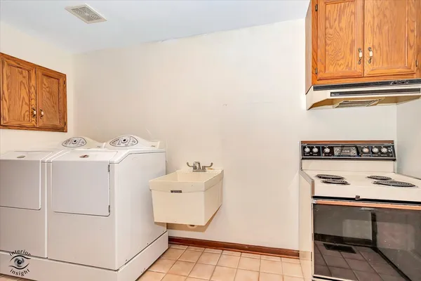 a view of a room with refrigerator and washer