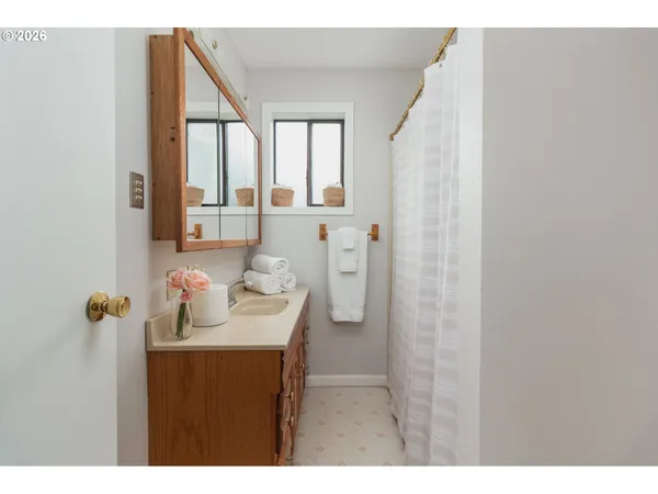 a bathroom with a sink vanity and a mirror