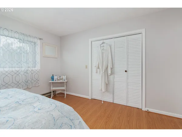 a bedroom with a bed and a chair