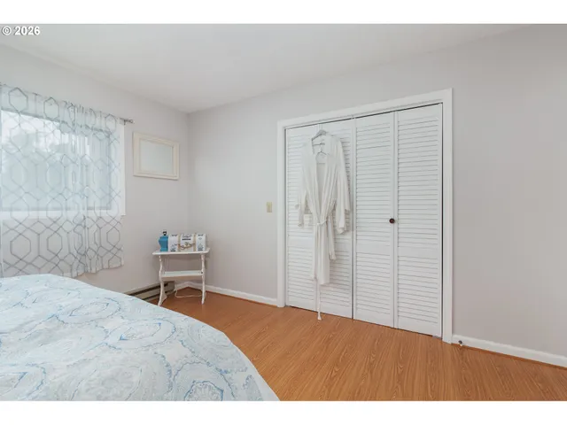 a bedroom with a bed and a chair