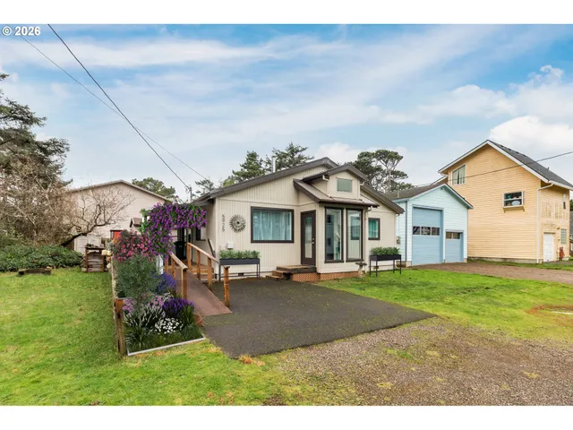 a view of a house with a big yard and large trees