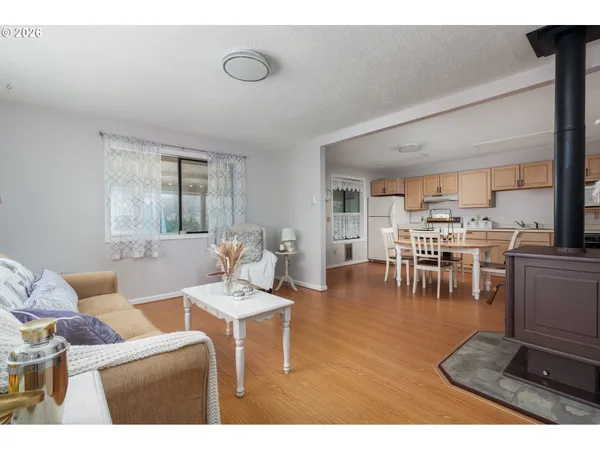 a living room with furniture a view of dining room and kitchen view