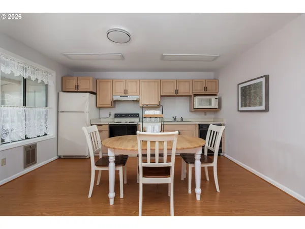 a view of kitchen with cabinets table and chairs